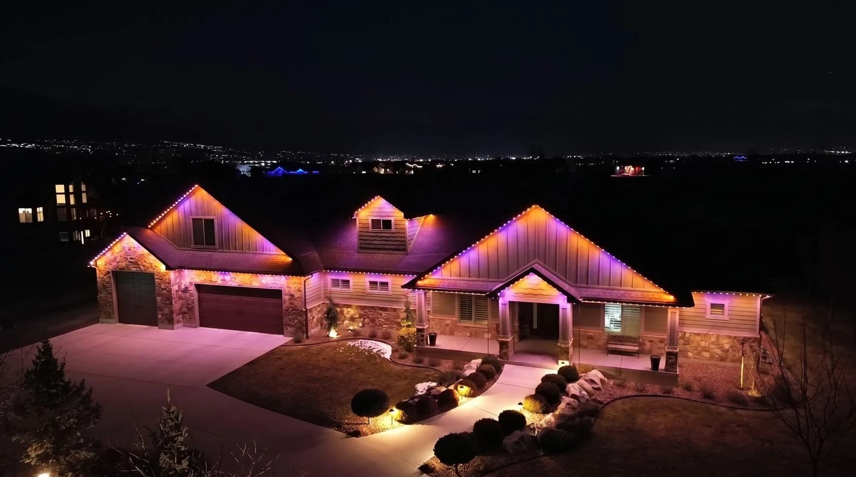 TruLight permanent lighting set to orange and purple for Halloween on a home (TruLight network scene)